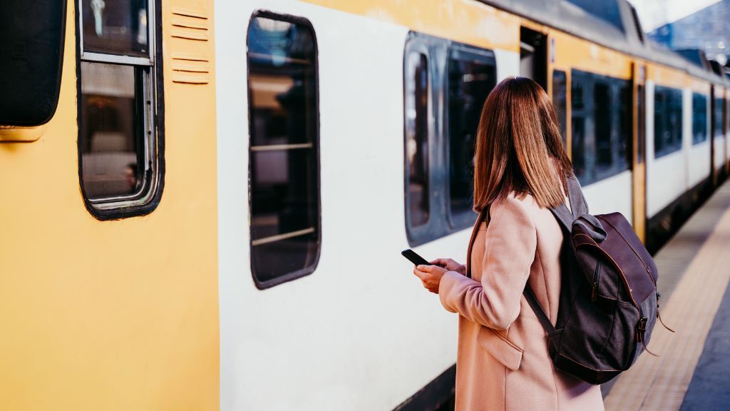 Train from Poland to Amsterdam - why is it worth it? Woman standing in front of a train