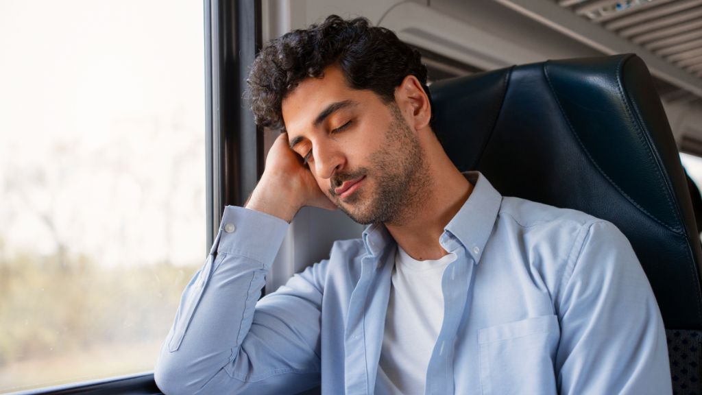 Amsterdam train with change in Frankfurt A man sleeping on a train